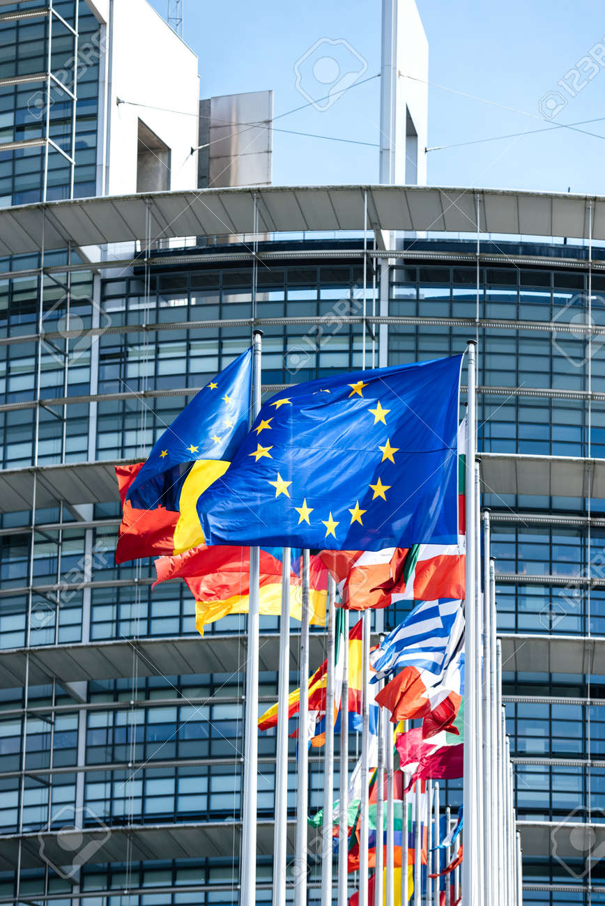 124900885-vertical-image-flags-of-all-member-states-of-the-european-union-waving-in-calm-wind-in-front-of-the